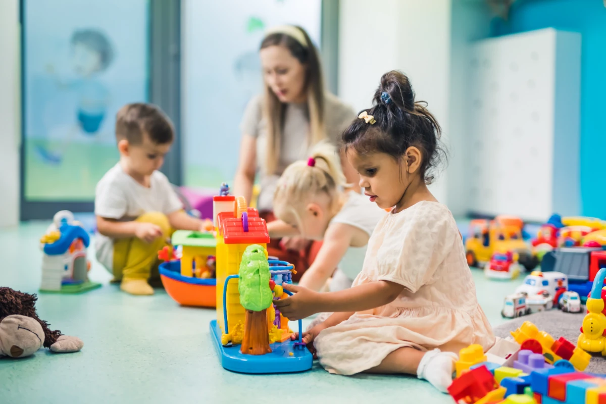 Toddlers exploring different toys in the Zebra Room, building confidence and independence