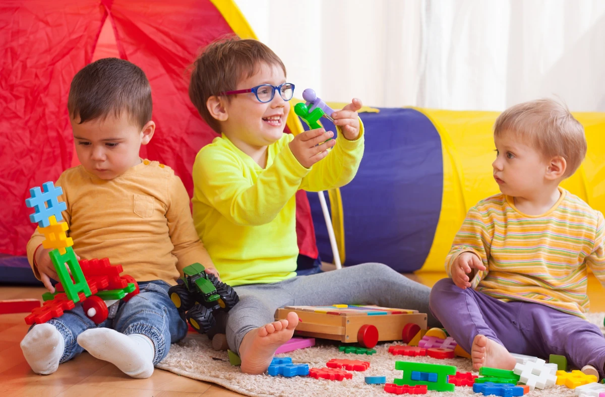 Happy toddlers playing together, building teamwork and social skills in a nurturing environment