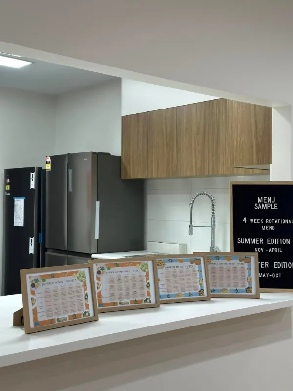 Centre kitchen display showing the four-week rotating menu plan for children, highlighting seasonal and nutritious options.