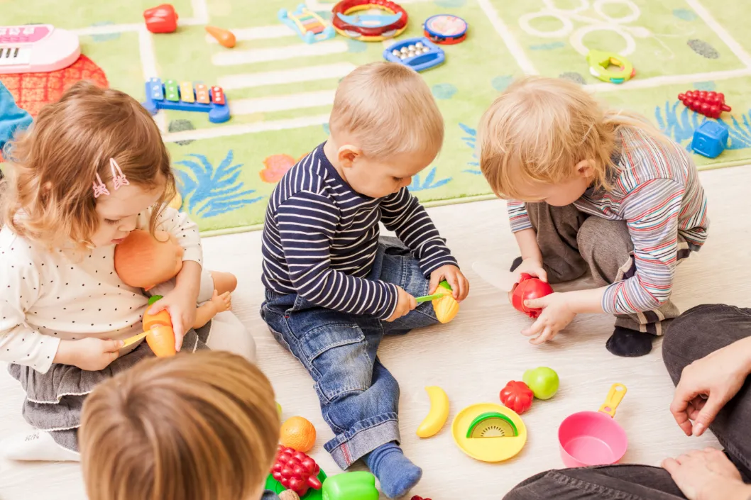 Young toddlers enjoying social play together, building first friendships and learning through role play